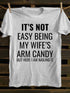 Unisex It's Not Easy Being My Wife's Arm Candy T-shirt