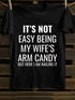 Unisex It's Not Easy Being My Wife's Arm Candy T-shirt